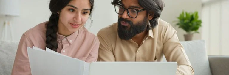 A young couple reviews financial documents. together.